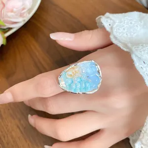 Exquisite close-up detail of a French vintage shell and light blue beaded ring