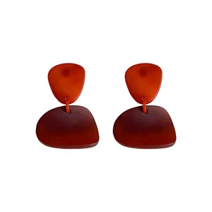 Retro irregular geometric gradient dangle earrings with amber resin effect on white background