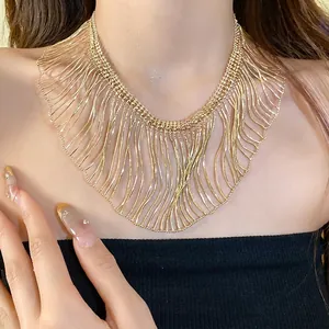 Statement gold metallic fringe snake chain necklace with elegant layered wave design