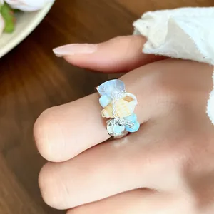 Detailed close-up of a French vintage ring featuring seashells, conchs, and blue beads.