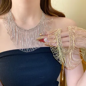 Detail view of silver and gold metal snake chain fringe necklaces worn by a model