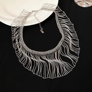 Detail view of metallic silver snake chain fringe necklace with intricate tassel design.