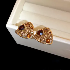 Elegant vintage heart-shaped stud earrings with amber crystals in a gold-tone finish.