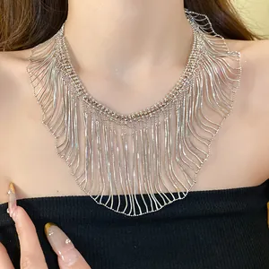 Exquisite close-up detail of a silver metallic snake chain tassel necklace worn by a model