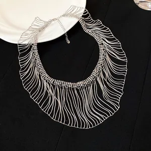 Close-up detail of silver snake chain fringe necklace with multi-layer wavy design