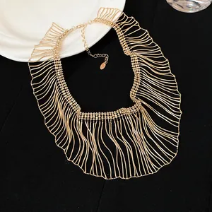 Detailed view of the layered gold snake chain fringe on a statement necklace