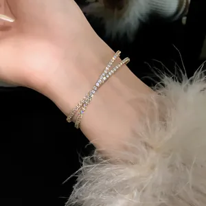 Close-up detail of a double-layer crisscross open bangle adorned with sparkling zircons.