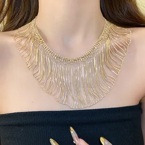 Close-up of elegant gold metal fringe necklace with multiple snake chain tassels