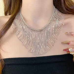 Close-up of a silver fringe snake chain necklace featuring a bold metallic tassel design.