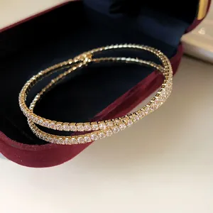 Close-up of a luxury double-layer criss-cross zircon open bangle in a jewelry box