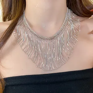 Detail of metallic fringe necklace with snake chain tassels on model