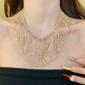 High-quality close-up detail of a layered gold snake chain fringe statement necklace