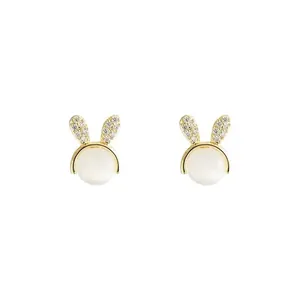 Elegant golden rabbit stud earrings featuring white cat-eye stones and sparkling zircons