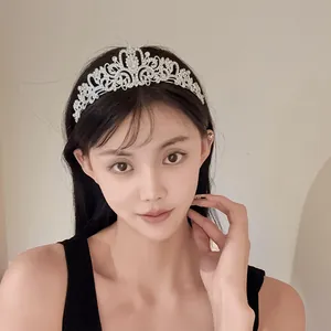 Elegant rhinestone flower crown tiara headband worn by a model for a party hairstyle