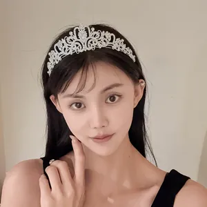 Elegant crystal flower tiara crown with teardrop stone worn by a model for party