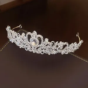Detailed macro view of elegant silver rhinestone flower and waterdrop tiara for parties.