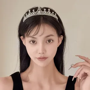 Close-up of an elegant sparkling silver rhinestone floral crown headband for parties