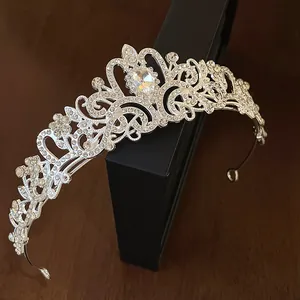 Detailed close-up of a silver rhinestone crown headband with a teardrop crystal centerpiece