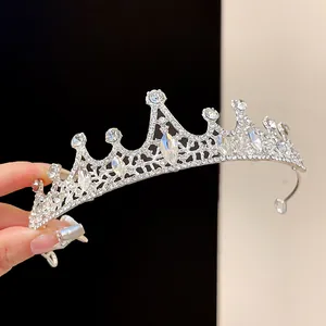 Detailed view of elegant silver crown headband with sparkling rhinestones and teardrop gems.