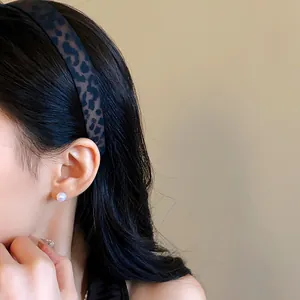 Close-up of vintage leopard print headband with frosted finish on model