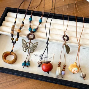Detailed view of ethnic bohemian ceramic necklaces with unique pendants on display tray