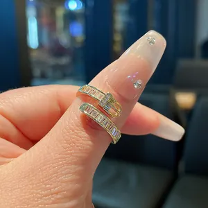 Macro view of a gold-plated belt buckle ring set with sparkling zircons on a finger