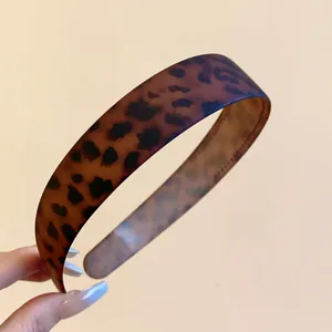 Close-up view of a matte leopard print headband with vintage chic style for daily hair accessories