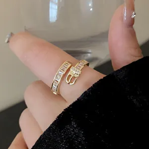 Detailed view of elegant gold plated belt buckle ring with sparkling zircon stones