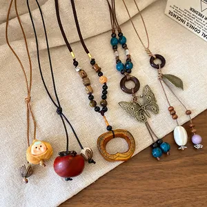 Detailed view of ethnic Bohemian necklaces with ceramic beads and butterfly pendant