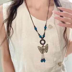 Bohemian vintage necklace with butterfly pendant and blue ceramic beads