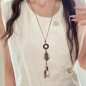 Detailed view of bohemian ethnic necklace with ceramic beads and leaf pendant