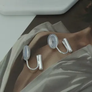 Detailed view of silver-toned U-shaped earring converters with clear silicone comfort pads