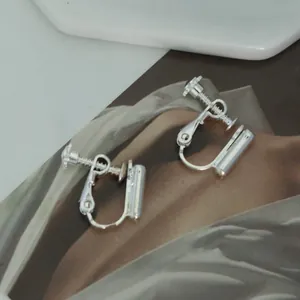 Detailed view of silver-colored adjustable screw-back clip-on earring converters.