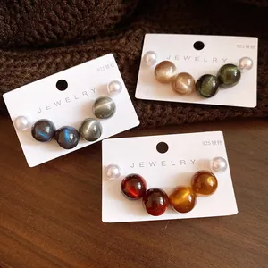 Close-up of colorful round resin pearl stud earrings on display cards