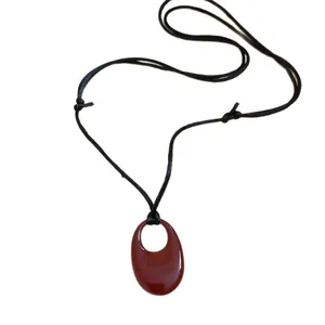 Adjustable black leather cord necklace featuring a glossy dark red oval ring pendant jewelry