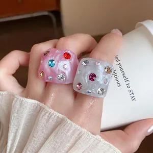 Chunky marbled acrylic rings with colorful rhinestones set in pink and white acrylic