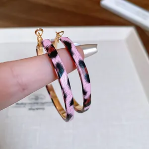 Vintage pink leopard print fabric-wrapped hoop earrings with stylish gold-tone interior