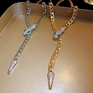 Snake-shaped pavé rhinestone link necklace in silver and gold tones
