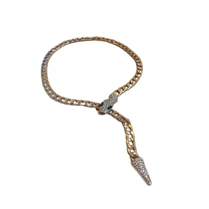 Exquisite gold Cuban chain necklace featuring a rhinestone-encrusted snake head with green eyes