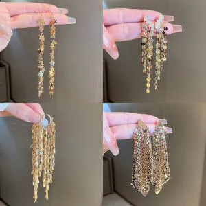 Detailed collection of four styles of golden sequin and tassel earrings for women