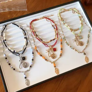 Detailed view of ethnic style beaded multi-layer necklaces with vintage charms
