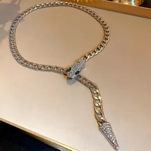 Close-up of silver-toned snake necklace with crystal eyes and rhinestone details