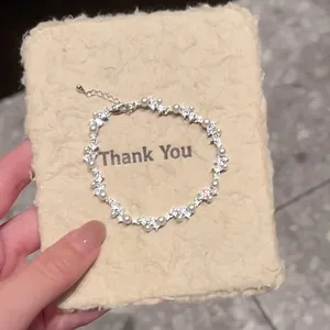 Detail of Korean style irregular bracelet featuring white pearls and sparkling zircons