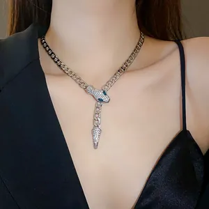 Close-up of silver-tone rhinestone-encrusted snake necklace on model