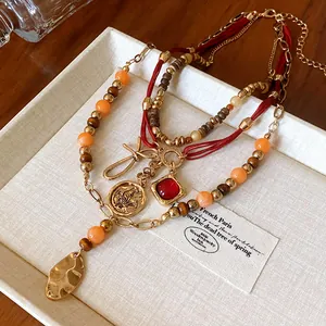 Detailed view of multi-layered ethnic beaded necklace with vintage pendants