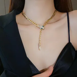 Close-up of elegant gold-tone snake necklace with sparkling rhinestones on model
