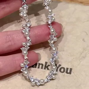Detailed close-up of a luxury irregular bracelet with sparkling zircons and white pearls