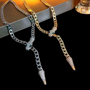 Detailed view of gold and silver snake necklaces with glittering rhinestone accents