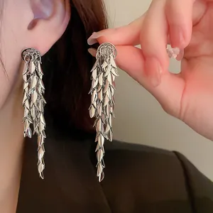 Close-up detail of silver leaf sequin tassel earrings with elegant shimmering fringe