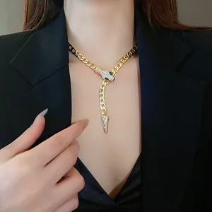Close-up of a gold snake-shaped necklace with sparkling rhinestone details
